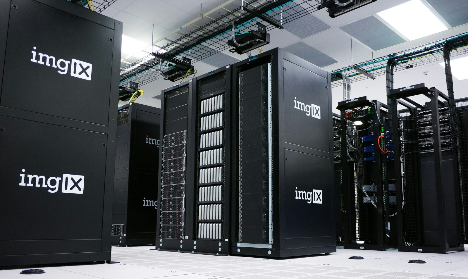 Rows of server racks receding down a data-centre aisle