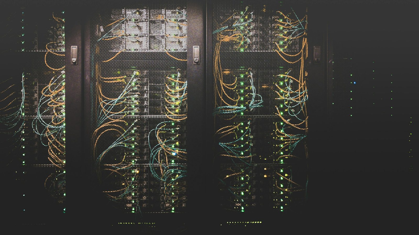 Neatly dressed network cabling running into a rack of switches